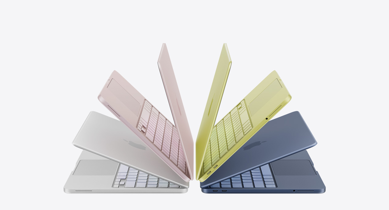 Plusieurs ordinateurs portables MacBook Neo couleur argent, rose poudré, jaune agrume et indigo, légèrement ouverts et disposés en demi-cercle